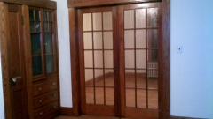 French Doors between parlor and library, built ins to the left.